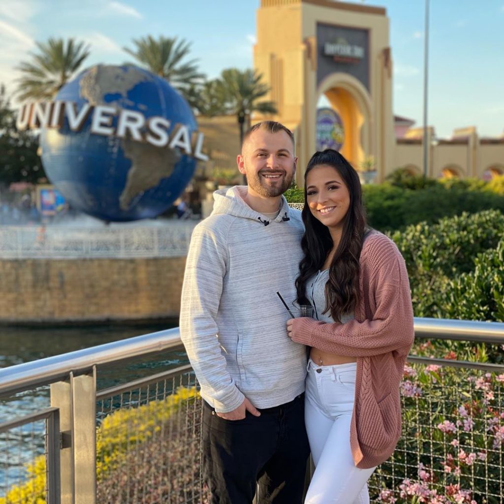 A couple standing in front of the Universal Studios Florida entrance